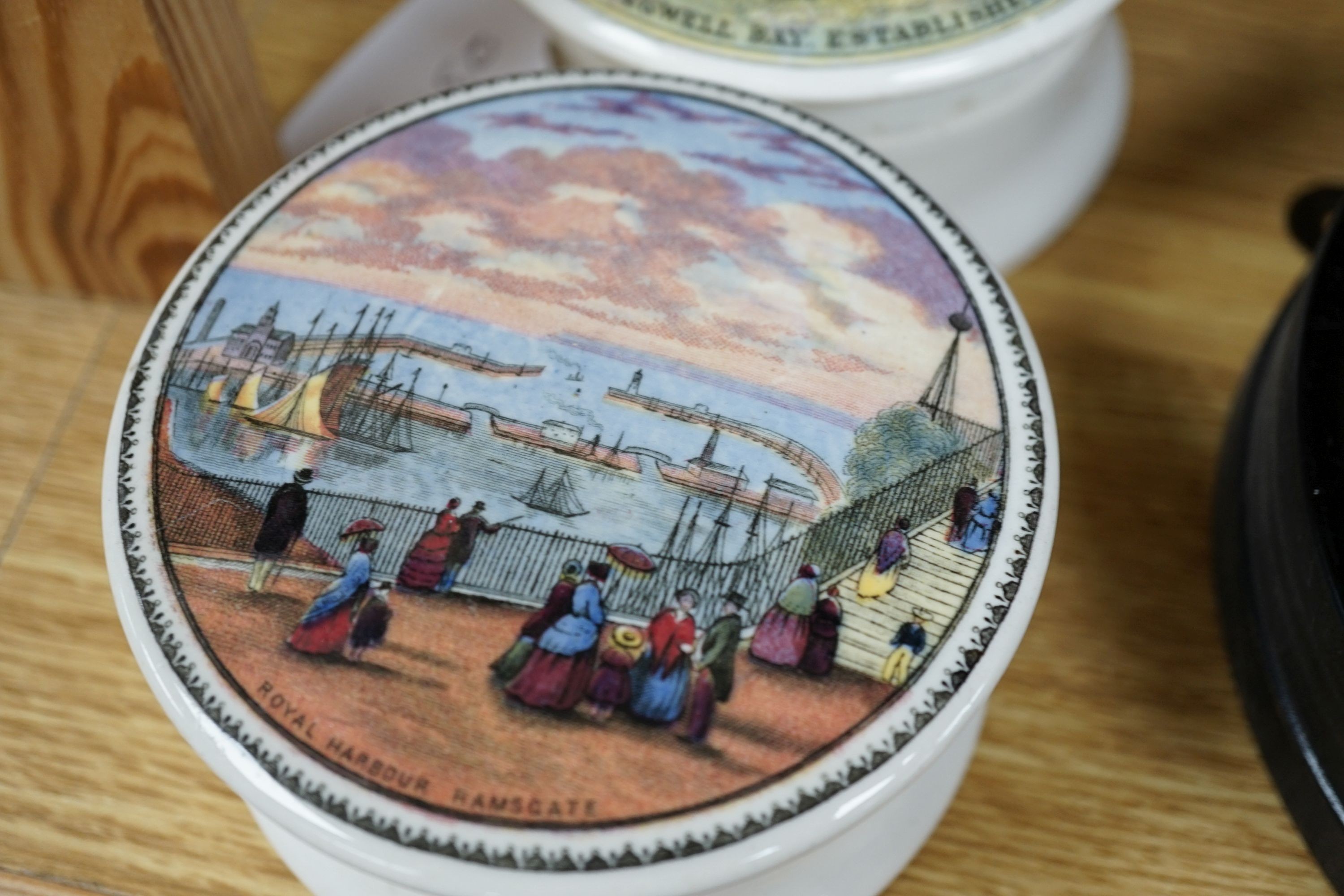 Seven Prattware pot lids, mounted in ebonised wood frames, an F & R Pratt plate and two pot lids with bases